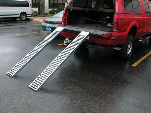 Steel pickup van ramp is serrated to prevent slippage.