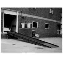 Beacon dock yard ramps allow workers to load and unload trucks, rail cars and trailers from ground level at facilities that have no freight dock. The loading dock yard ramps are operated via a manual 2-speed hand crank. Dock yard ramp features positive traction open steel grating, safety locking chains, 9" steel wheels, rubber bumpers, 4" high steel safety curbs and a 15" overlap lip. Dock yard ramps are an essential dock-area material handling equipment item.