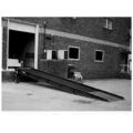 Beacon dock yard ramps allow workers to load and unload trucks, rail cars and trailers from ground level at facilities that have no freight dock. The loading dock yard ramps are operated via a manual 2-speed hand crank. Dock yard ramp features positive traction open steel grating, safety locking chains, 9" steel wheels, rubber bumpers, 4" high steel safety curbs and a 15" overlap lip. Dock yard ramps are an essential dock-area material handling equipment item.