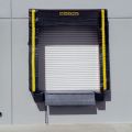 Beacon loading dock door seal with auto head curtain features wrap-around-style material to protect the wood and foam from the outside elements. The overhead dock door seal features safety yellow guide strips and breather slots on the side and head pads. The auto head curtain protects the area above 8' high that is not covered by the trailer. Loading dock door seal keeps out rain, snow and dust.