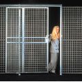 The Beacon pre-engineered wire mesh partition is designed to limit access to and secure important items. This security room allows light penetration and air circulation while keeping its contents secure. The wire mesh partition or computer security room features panels made from 8-gauge steel 1-1/2" x 3" welded wire. The posts are 2" x 2" x 14 gauge welded to a 7" x 2" x 1/4" mounting plate. The slide doors have a 96" clear height. The security room is re-locatable and features a versatile modular design for easy setup. The panels stack together horizontally to form partitions with heights of 8', 10' or 12'. Wire mesh partition allows air circulation and light penetration.